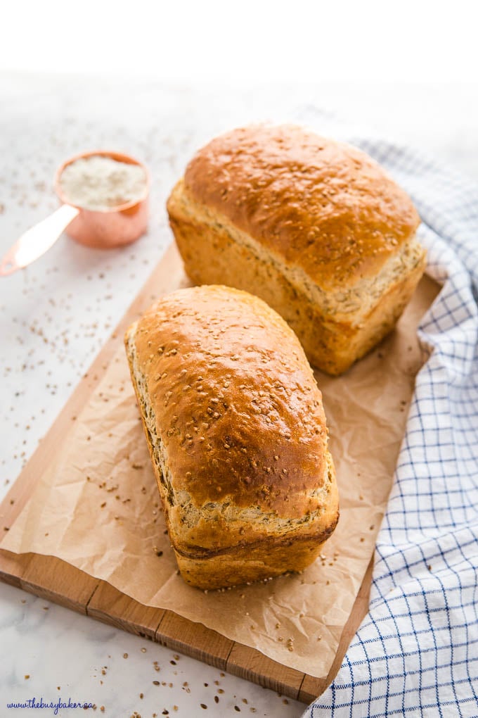 2 loaves of whole grain bread on a wooden cutting board