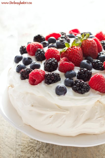 The Perfect Pavlova recipe makes a delicious and showstopping easy-to-make gluten-free dessert that's also on the healthier side! Recipe from thebusybaker.ca!