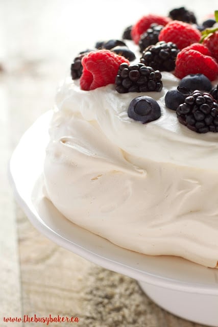 The Perfect Pavlova recipe makes a delicious and showstopping easy-to-make gluten-free dessert that's also on the healthier side! Recipe from thebusybaker.ca!