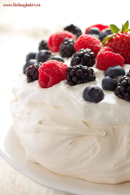 The Perfect Pavlova recipe makes a delicious and showstopping easy-to-make gluten-free dessert that's also on the healthier side! Recipe from thebusybaker.ca!