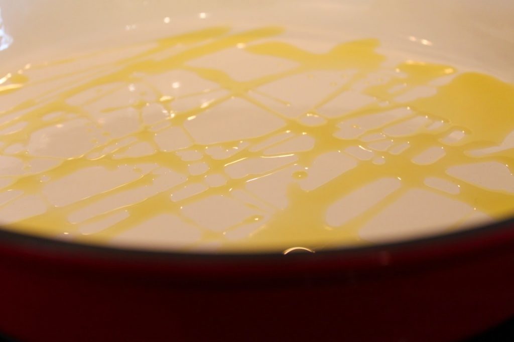 olive oil drizzled into a pan