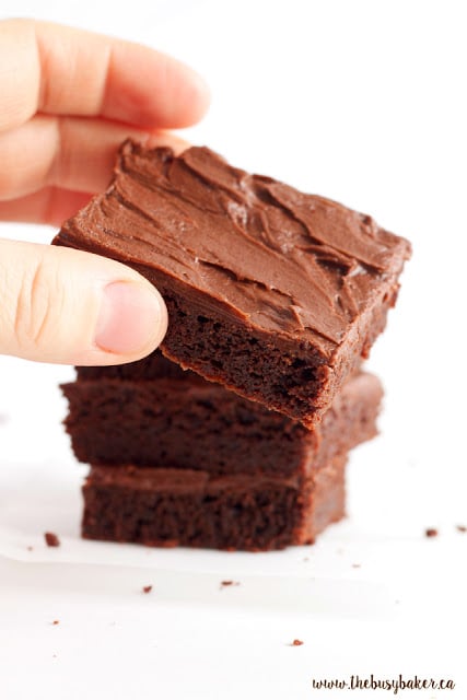 removing a fudgy brownie from the top of a stack