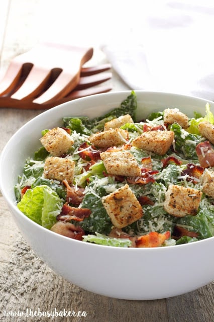 This Greek Yogurt Caesar Salad is a healthy and low fat alternative to traditional Caesar salad! It's ultra creamy and delicious and it's so easy to make! Recipe from thebusybaker.ca!