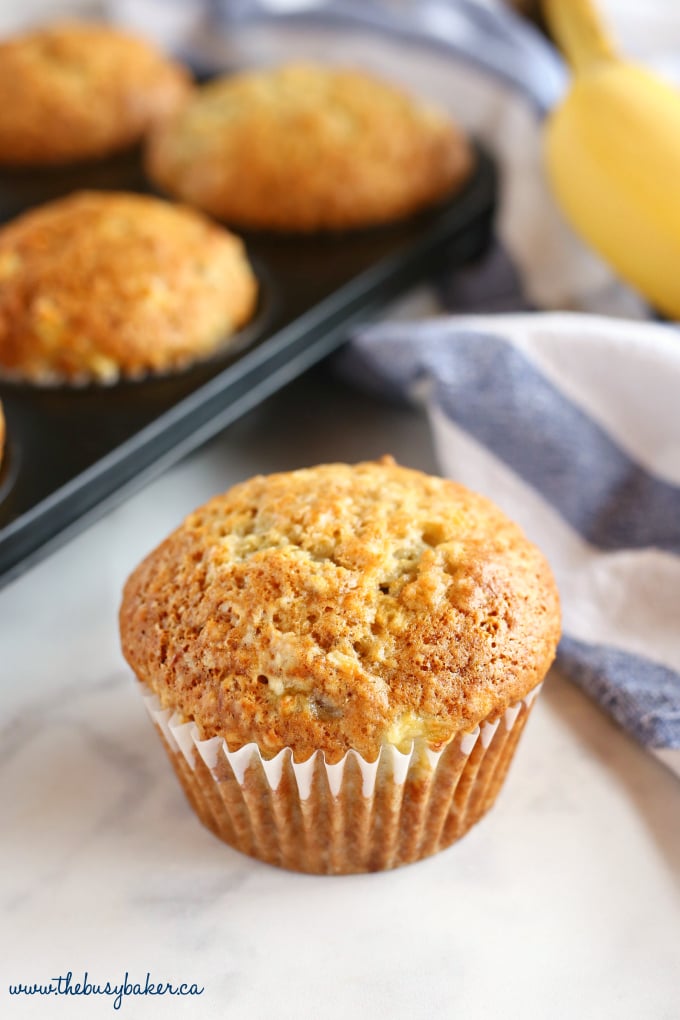 These Best Ever Banana Muffins are the best banana muffins you'll ever try - crispy on the outside and fluffy on the inside! And so easy to make in only one bowl! Ready in minutes! Recipe from thebusybaker.ca! #besteverbananamuffins #bestbananamuffins #bananamuffins #easymuffinrecipe