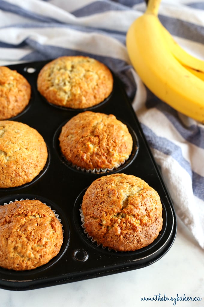 These Best Ever Banana Muffins are the best banana muffins you'll ever try - crispy on the outside and fluffy on the inside! And so easy to make in only one bowl! Ready in minutes! Recipe from thebusybaker.ca! #besteverbananamuffins #bestbananamuffins #bananamuffins #easymuffinrecipe