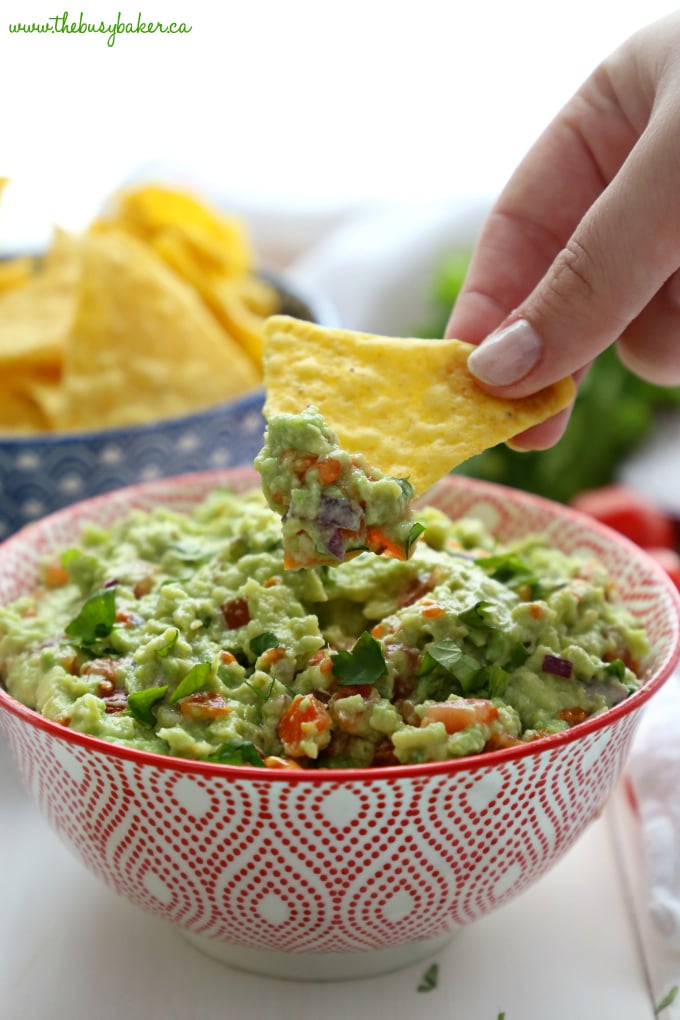 Dipping into Best Ever Healthy Guacamole with tortilla chips