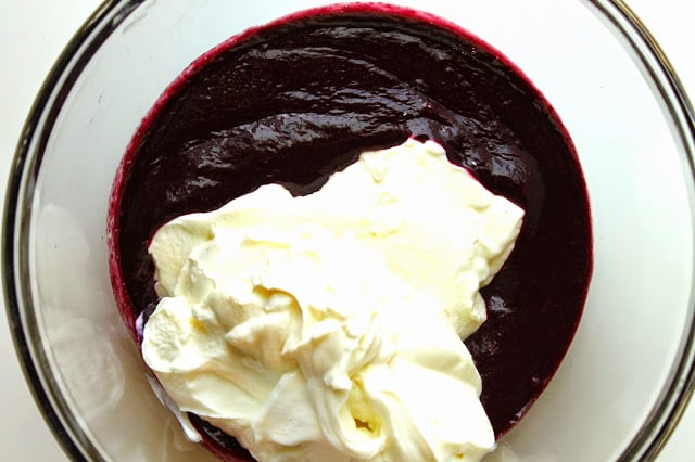 adding strained yogurt into blackberry puree