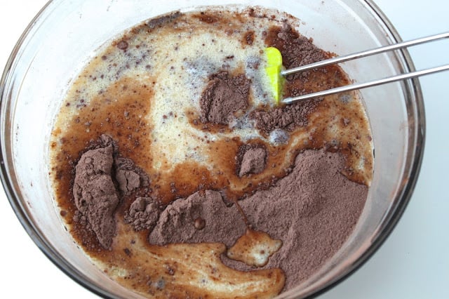 whisking eggs into chocolate cake batter
