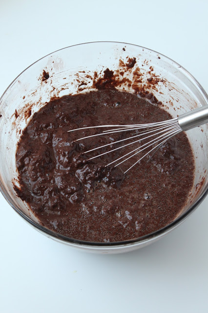combining chocolate cake ingredients in a bowl