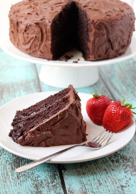 a serving of moist chocolate cake with chocolate frosting