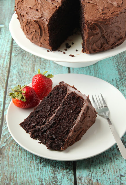 slice of chocolate layer cake with chocolate buttercream frosting