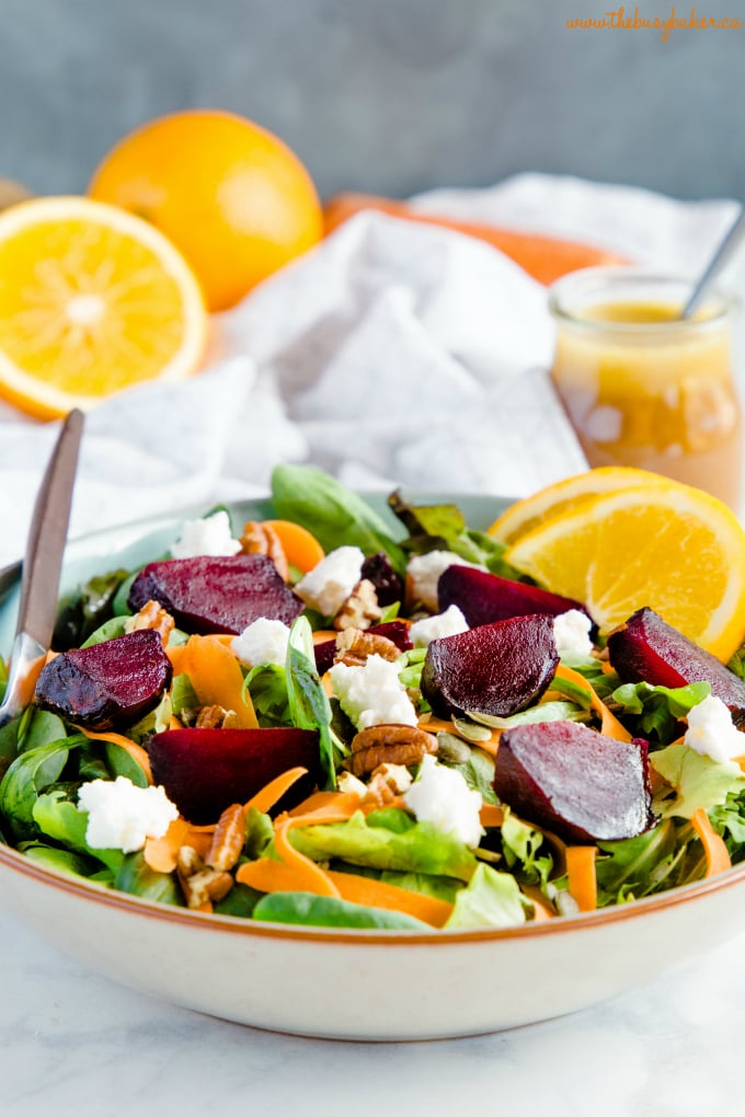 greens, topped with beets, nuts, seeds and carrots