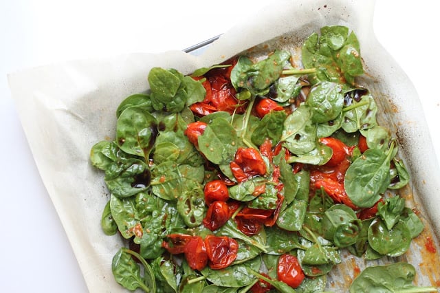 roasted cherry tomatoes tossed with baby spinach