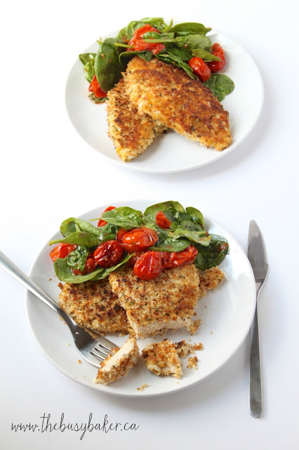 plated dinner of chicken Milanese with roasted tomatoes and spinach