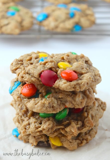 Monster Cookies are the perfect cookie recipe to make when you need a sweet treat! They're soft and chewy peanut butter oatmeal cookies studded with M&Ms. Homemade cookies don't get any better than these! a stack of homemade Monster Cookies