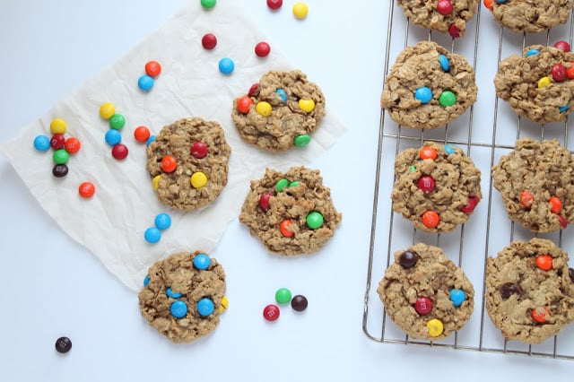 Monster Cookies are the perfect cookie recipe to make when you need a sweet treat! They're soft and chewy peanut butter oatmeal cookies studded with M&Ms. Homemade cookies don't get any better than these! peanut butter oatmeal cookies with M&M's on a cooling rack