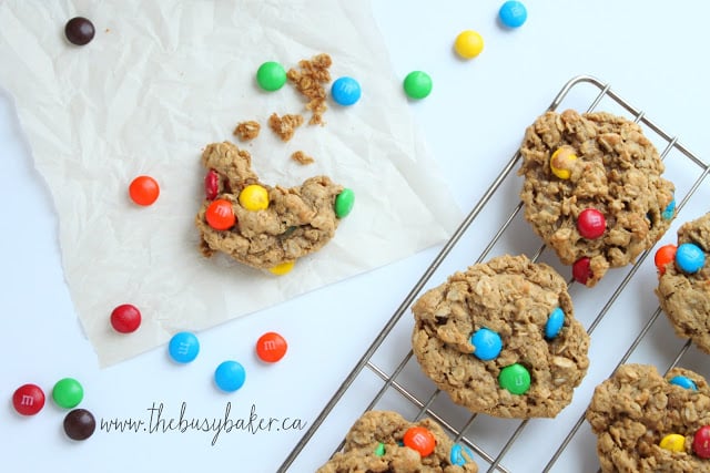 Monster Cookies are the perfect cookie recipe to make when you need a sweet treat! They're soft and chewy peanut butter oatmeal cookies studded with M&Ms. Homemade cookies don't get any better than these! M&M's surrounding a Monster Cookie with a bite taken out of it