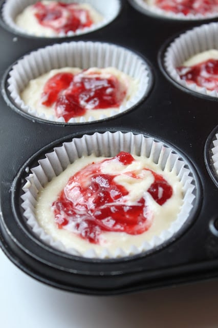Strawberry Cupcakes with Fresh Strawberry Buttercream are the perfect summer dessert, packed with fresh strawberries. You'll love this easy cupcakes recipe! #cupcakes #recipe #strawberries #desserts strawberry jam swirled into vanilla cupcake batter to make strawberry swirl cupcakes
