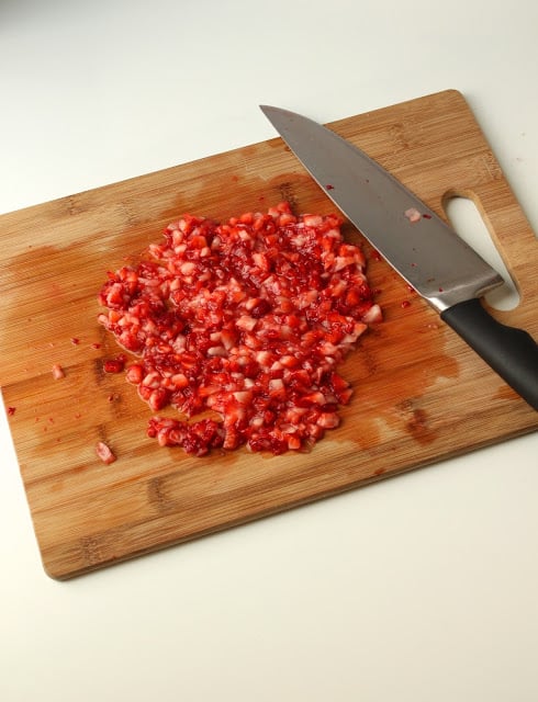 finely chopped fresh strawberries on a cutting board