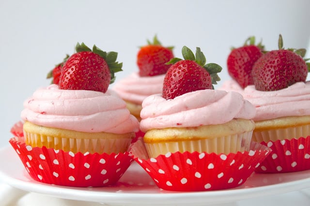 Strawberry Cupcakes with Fresh Strawberry Buttercream are the perfect summer dessert, packed with fresh strawberries. You'll love this easy cupcakes recipe! #cupcakes #recipe #strawberries #desserts platter of strawberry cupcakes with strawberry buttercream frosting