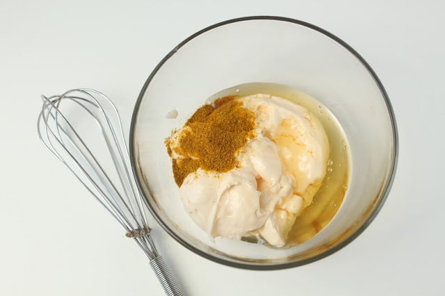 ingredients in a bowl for making sweet curry aioli dipping sauce