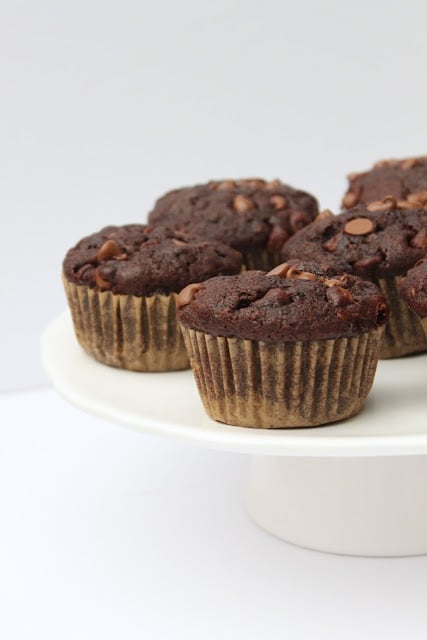 These healthier Double Chocolate Zucchini Muffins are packed with veggies and they're a more wholesome way to satisfy your chocolate cravings! Recipe from thebusybaker.ca!