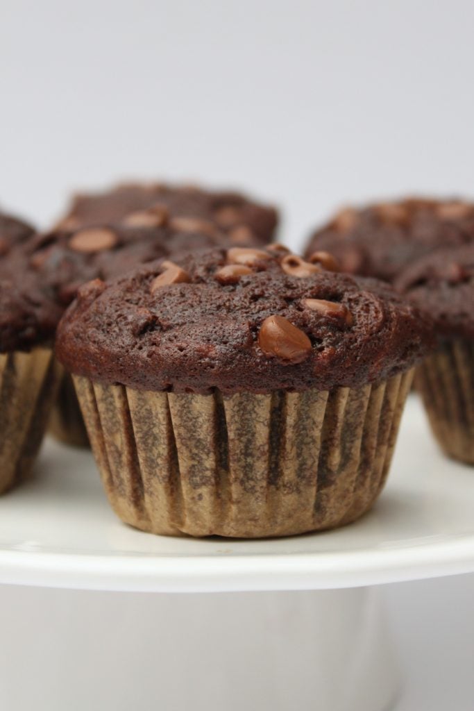 These healthier Double Chocolate Zucchini Muffins are packed with veggies and they're a more wholesome way to satisfy your chocolate cravings! Recipe from thebusybaker.ca!