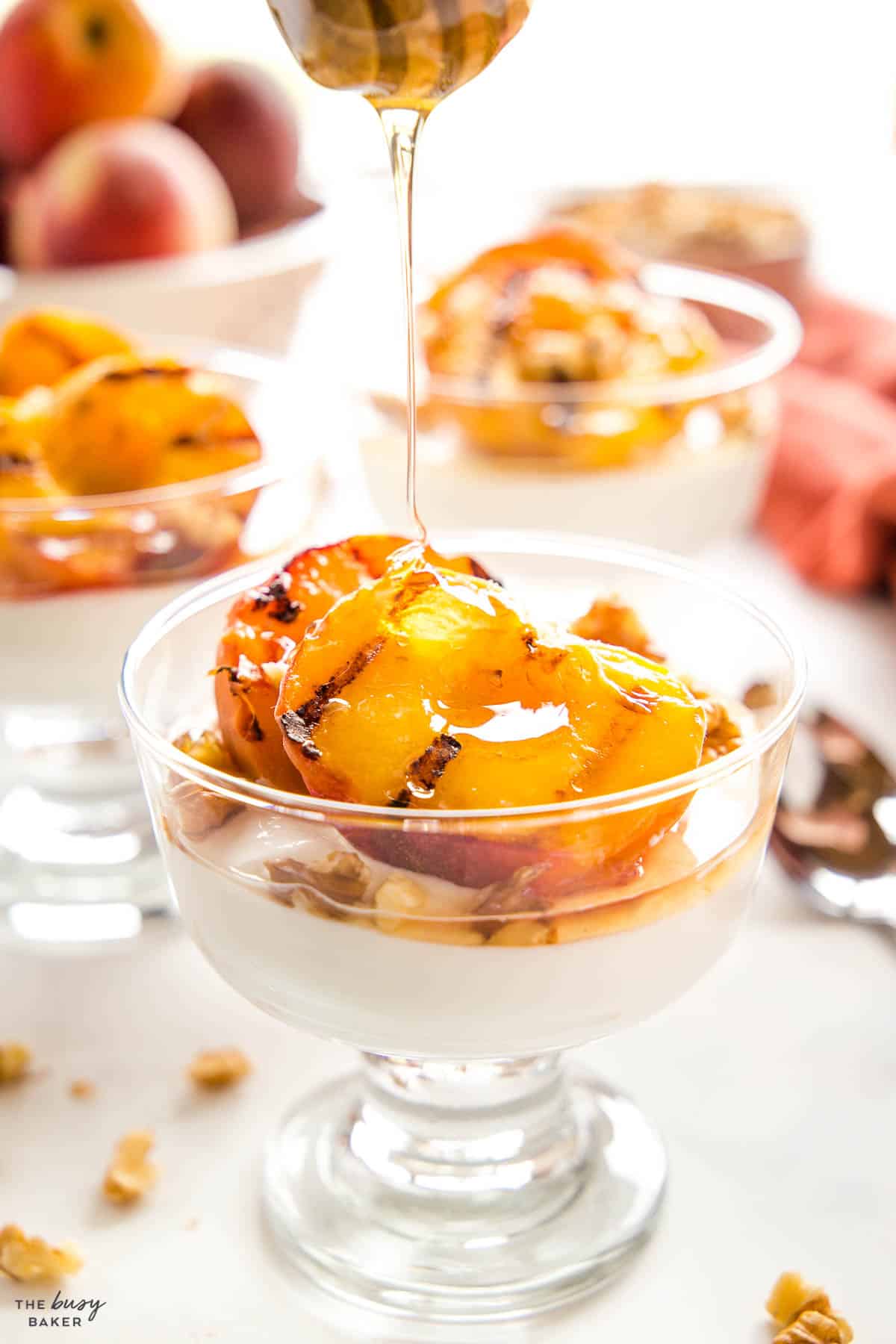 grilled peaches with honey pouring