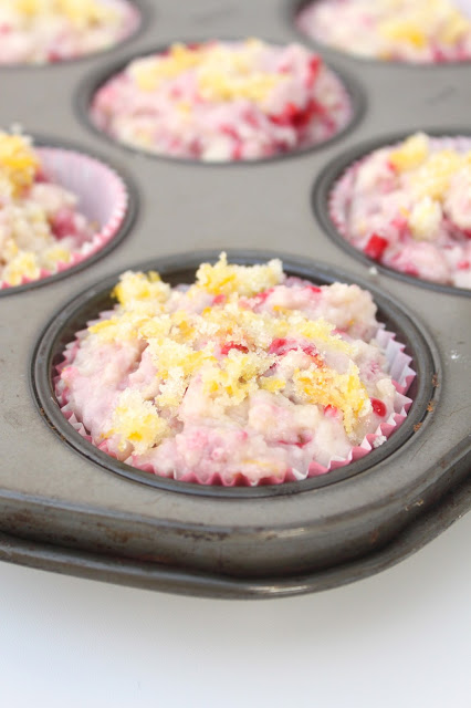 muffin pan filled with unbaked raspberry lemonade muffins batter