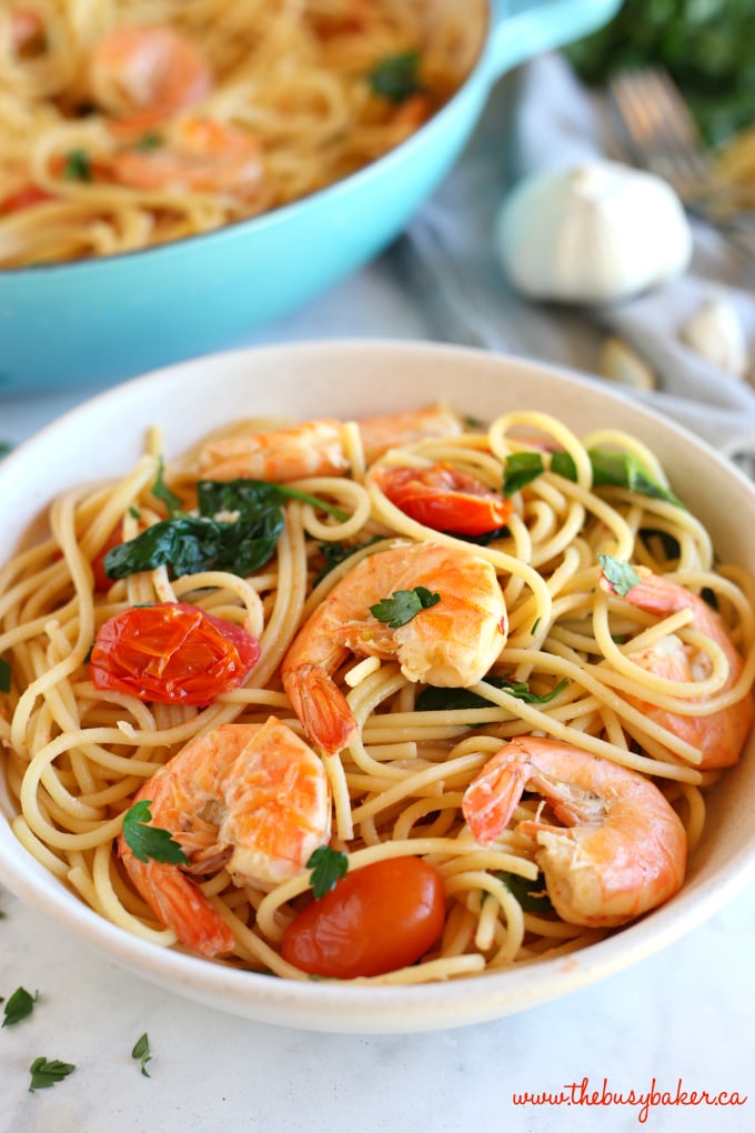 This Easy Healthy Shrimp Scampi is a delicious and healthy weeknight meat featuring fresh shrimp, pasta and veggies in a light-tasting garlic cream sauce! Recipe from thebusybaker.ca! #shrimpscampi #easyshrimppasta #healthyshrimppasta #healthyshrimpscampi 