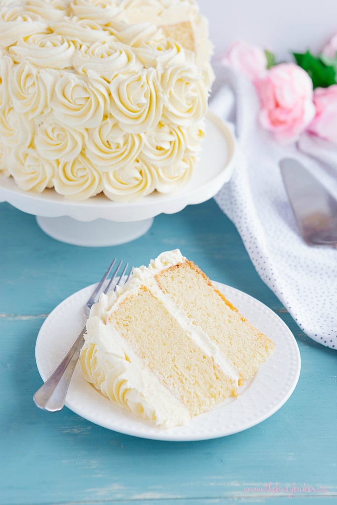 Best Ever Vanilla Bean White Cake slice on plate with fork