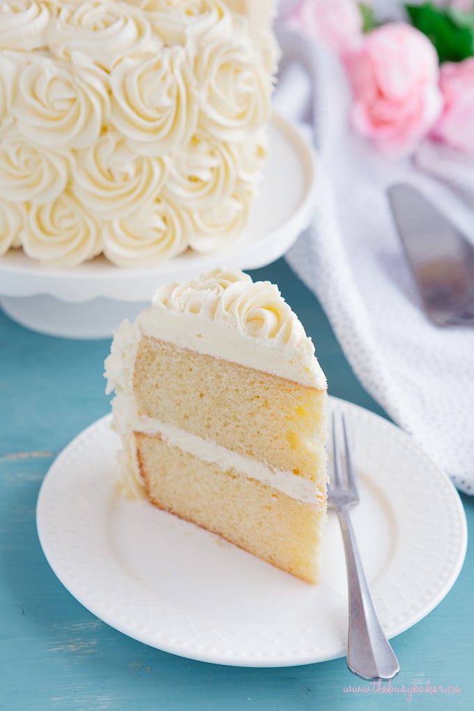 Best Ever Vanilla Bean White Cake slice on plate with fork