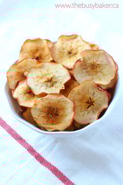 This apple chips recipe is easy to make, and homemade apple chips are the perfect healthy snack for a fall day. Great for packing into lunch boxes, too! bowl of homemade apple chips