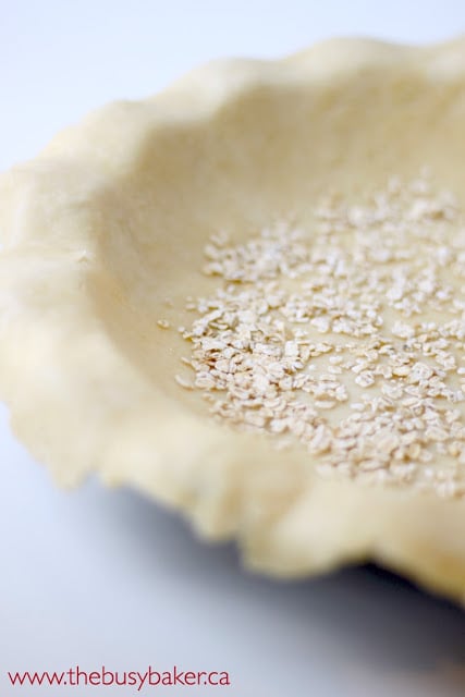 unbaked pie crust with a dusting of rolled oats in the center