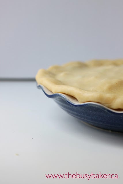 crimping pastry crust into a pie pan