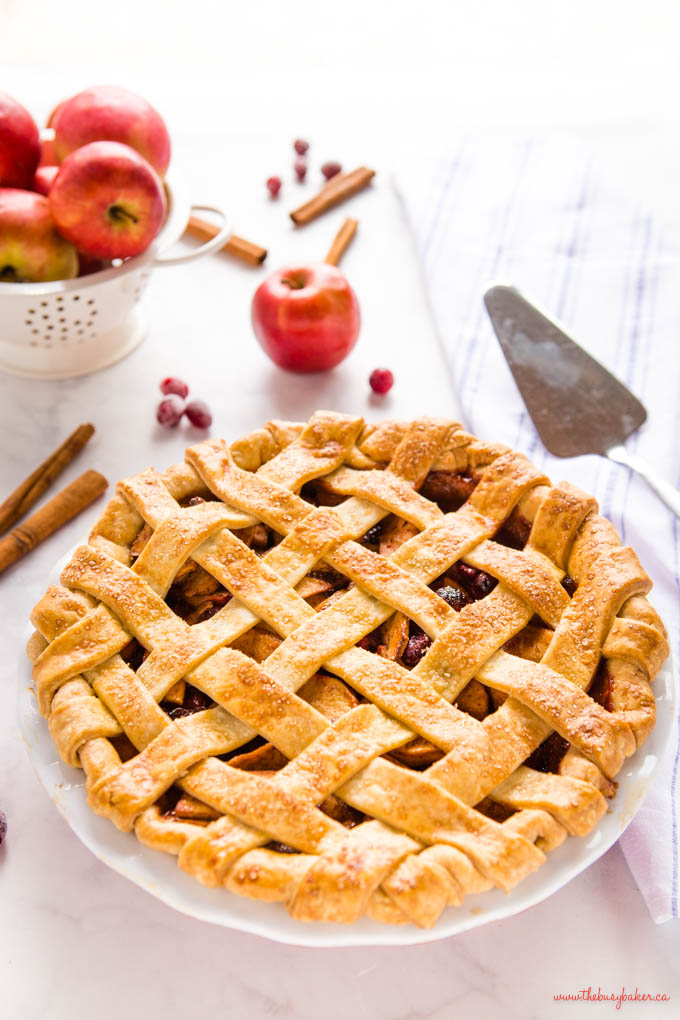 cranberry apple pie in white pie dish with lattice top