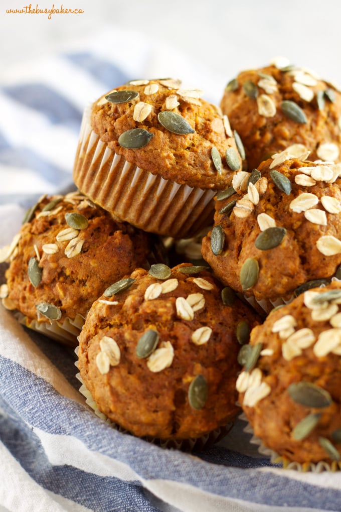 muffins stacked in on a blue and white striped towel