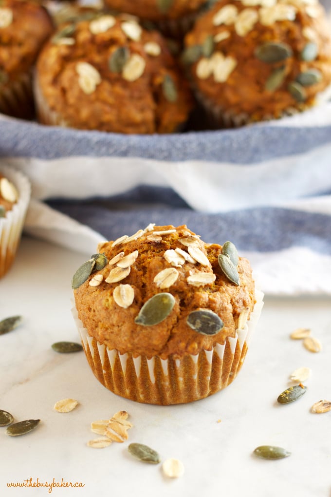 closeup image: pumpkin muffin with seeds and oats