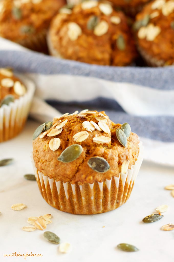 One pumpkin muffin with pumpkin seeds on top