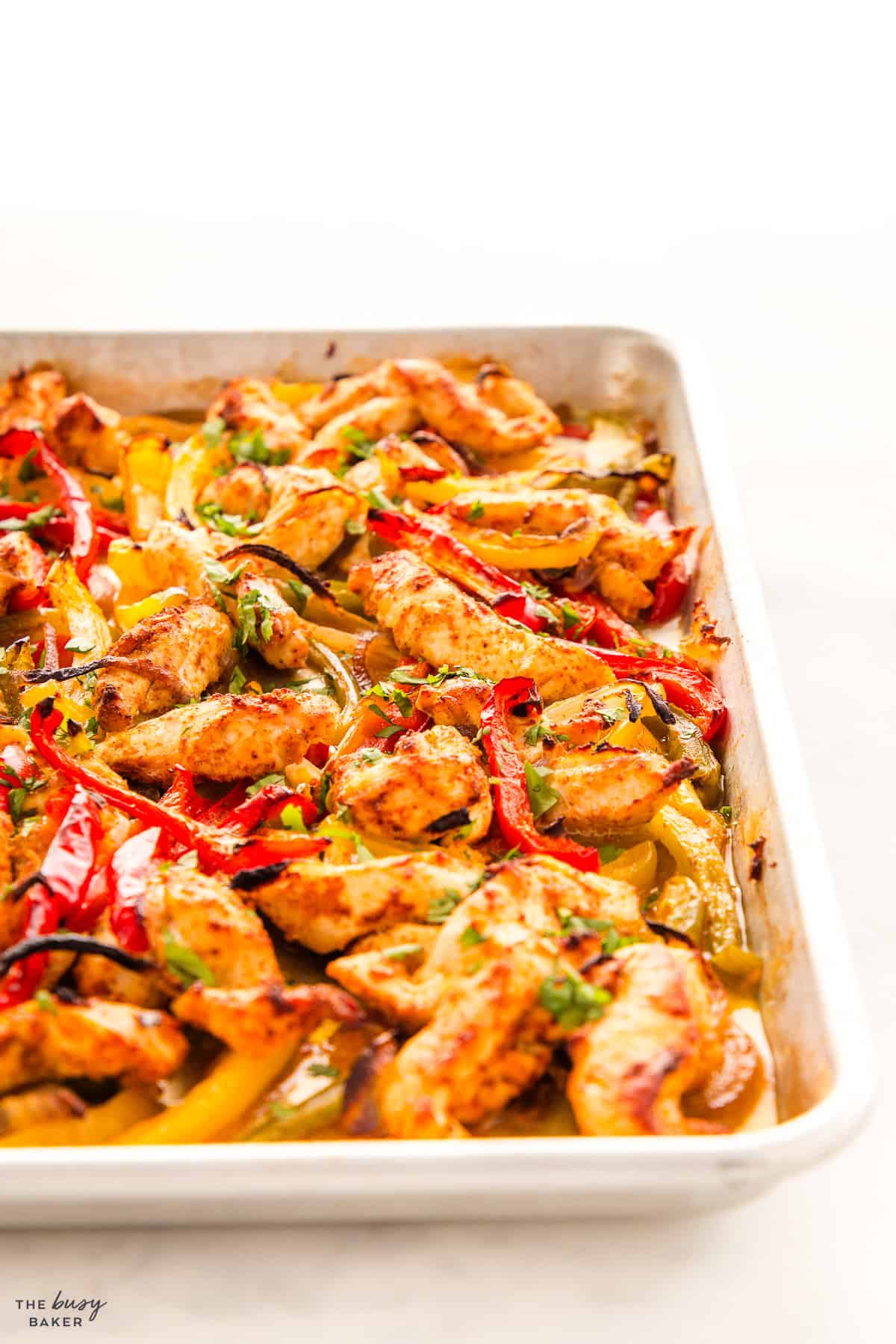 caramelized chicken and peppers on a sheet pan