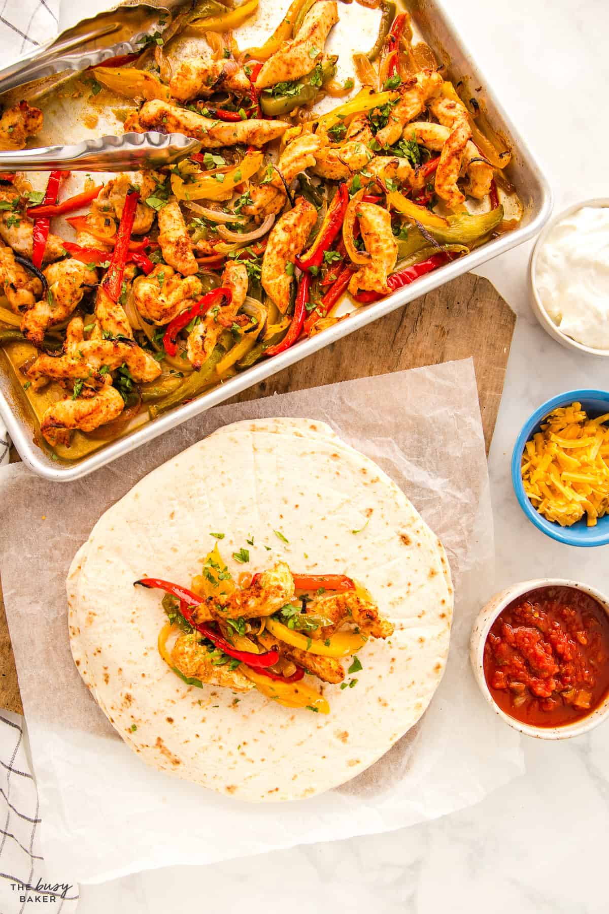 overhead image: chicken fajitas with the filling on a sheet pan