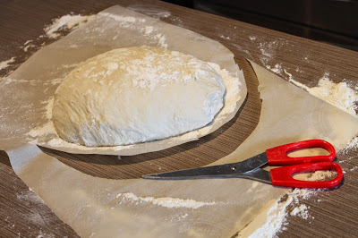 shaping a loaf of no knead artisan bread dough