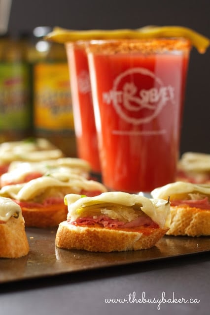 platter of party appetizers with corned beef, sauerkraut, Swiss cheese and thousand island dressing on bite sized baguettes