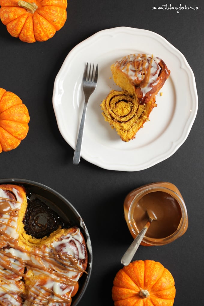 These soft and moist Pumpkin Spice Cinnamon Rolls are the perfect fall treat made with real pumpkin, fragrant spices and an easy cream cheese glaze! Recipe from thebusybaker.ca! #PumpkinSpice