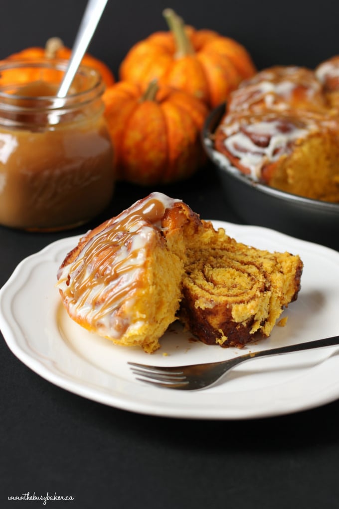 These soft and moist Pumpkin Spice Cinnamon Rolls are the perfect fall treat made with real pumpkin, fragrant spices and an easy cream cheese glaze! Recipe from thebusybaker.ca! #PumpkinSpice