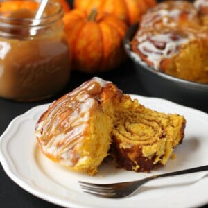 These soft and moist Pumpkin Spice Cinnamon Rolls are the perfect fall treat made with real pumpkin, fragrant spices and an easy cream cheese glaze! Recipe from thebusybaker.ca! #PumpkinSpice