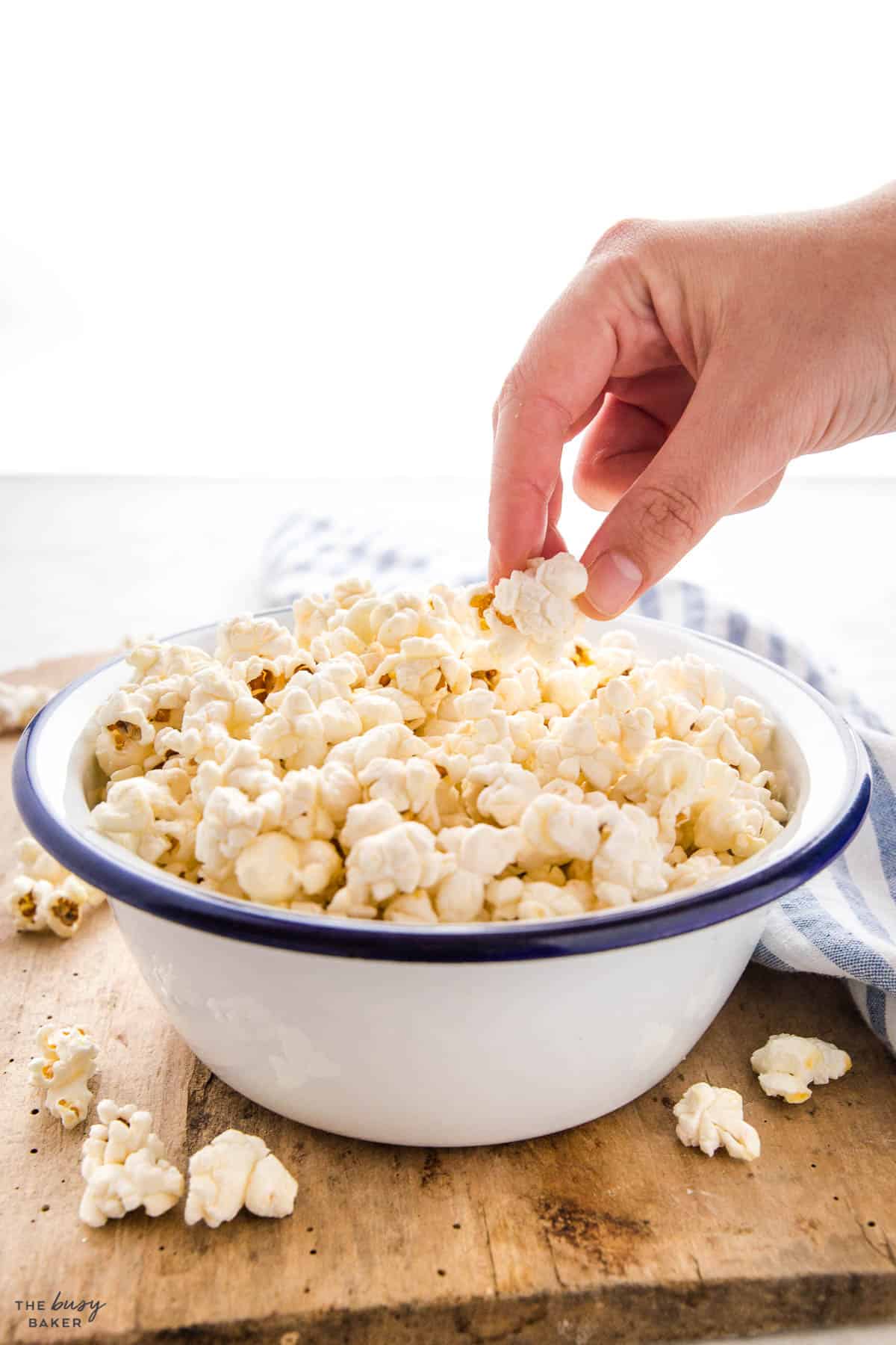 hand reaching for a kernel of kettle corn popcorn