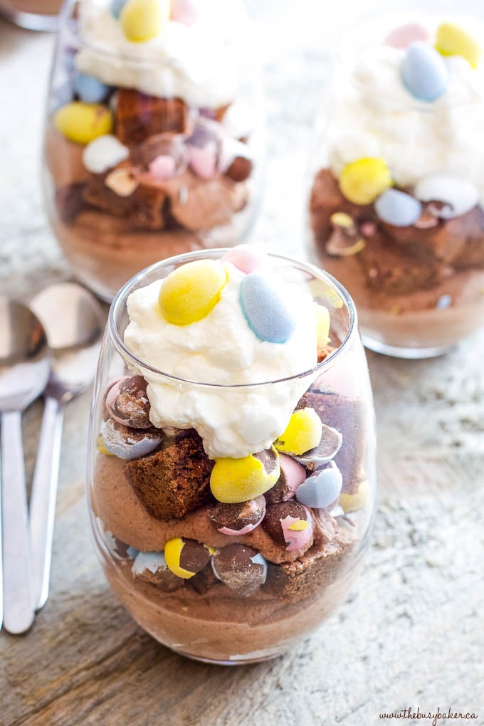 candy coated easter eggs in brownie dessert with cream