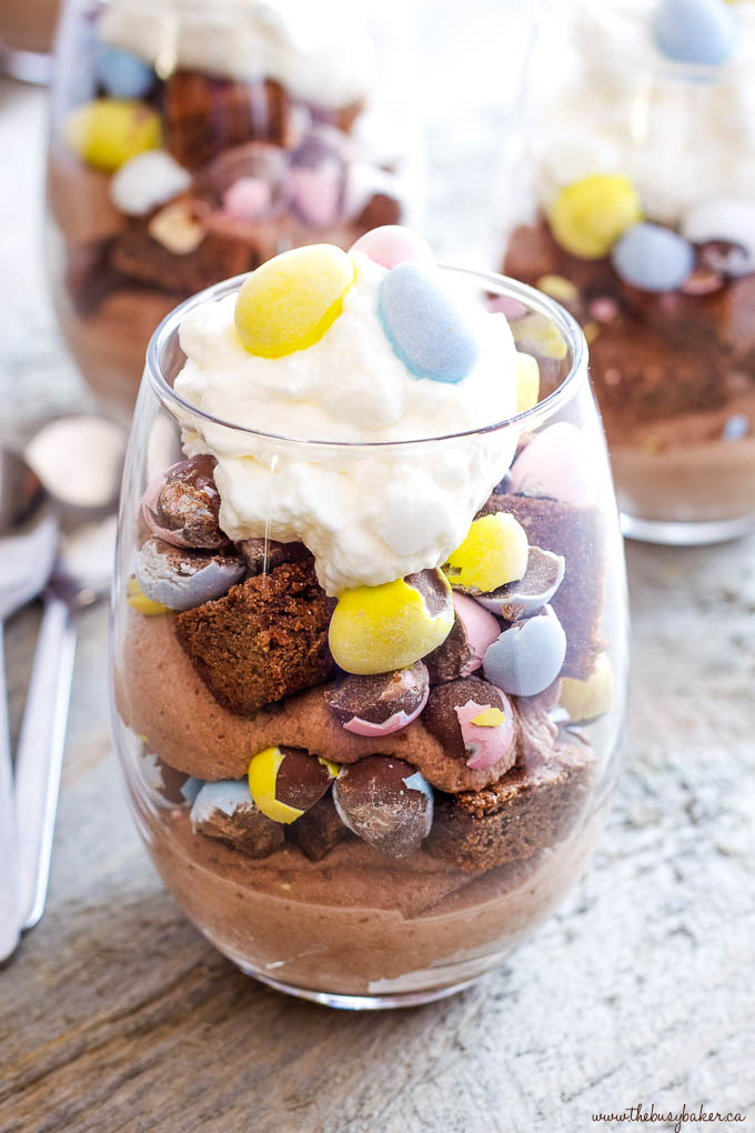 dessert parfait in stemless wine glass with brownies, mini eggs and cream