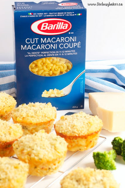 Broccoli Mac and Cheese Muffins next to a box of Barilla brand cut macaroni pasta